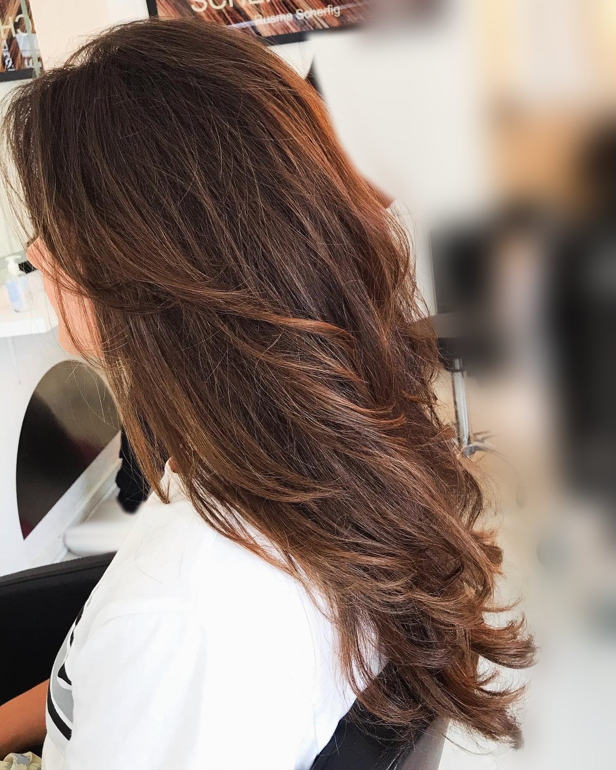 Italian layered haircut on long brown hair with layers, volume and natural movement