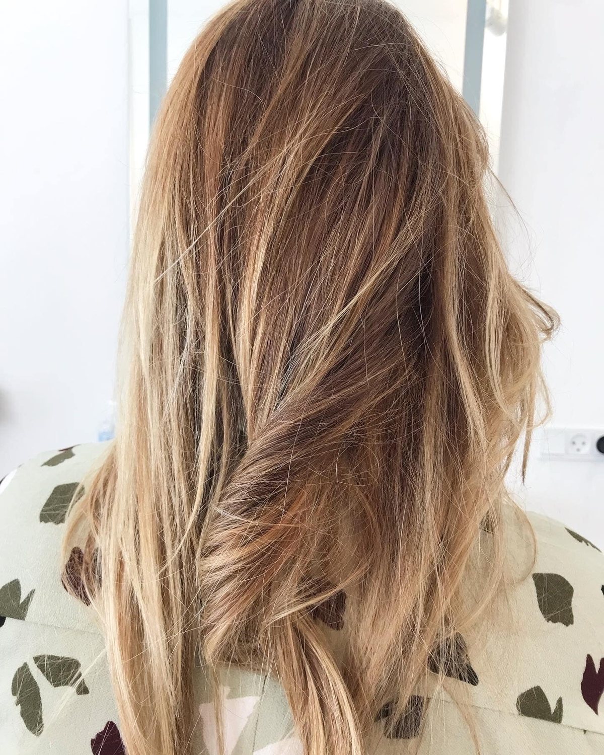 Shatush lightening on blonde hair with soft sun-kissed transitions and no visible regrowth line